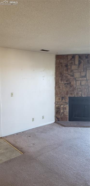 814 Tenderfoot Hill Road, Unit 102 Colorado Springs, CO 80906 - Photo 4 of 11 a view of an empty room with a fireplace