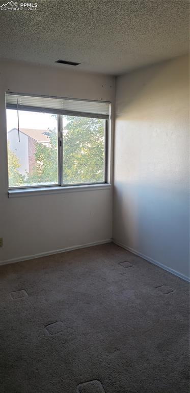 814 Tenderfoot Hill Road, Unit 102 Colorado Springs, CO 80906 - Photo 8 of 11 an empty room with a window