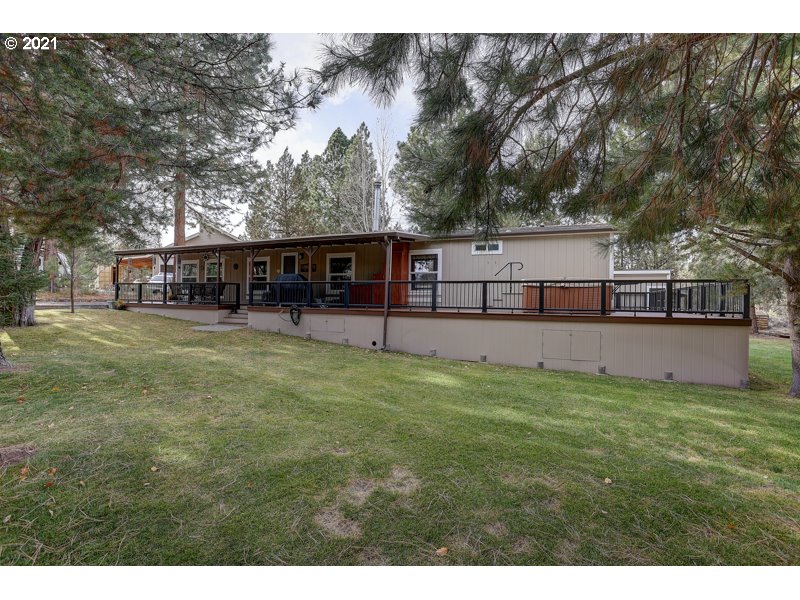 67367 Gist Road Bend, OR 97703 - Photo 1 of 32 a view of a house with wooden deck and a big yard