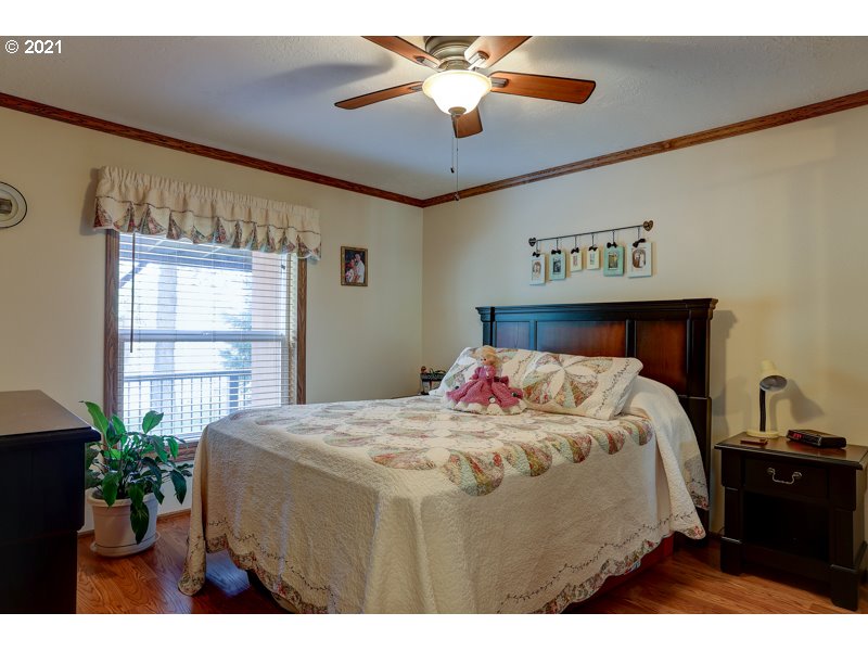 67367 Gist Road Bend, OR 97703 - Photo 11 of 32 a bedroom with a bed and a chandelier