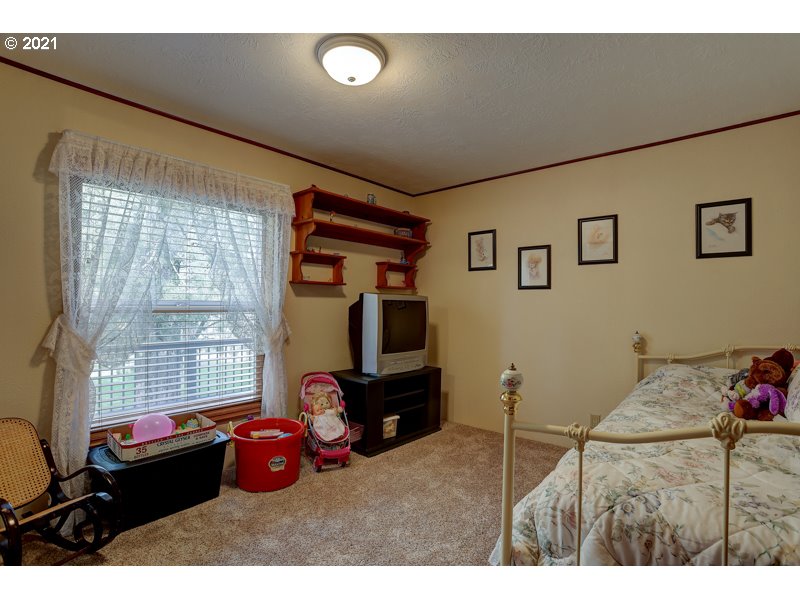 67367 Gist Road Bend, OR 97703 - Photo 14 of 32 a bedroom with a bed and wooden floor