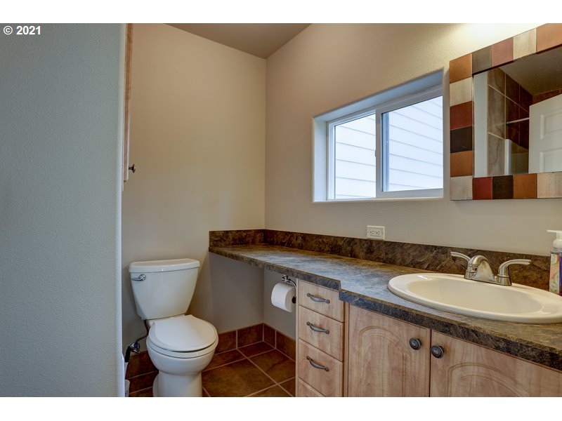 67367 Gist Road Bend, OR 97703 - Photo 24 of 32 a bathroom with a granite countertop toilet sink and mirror