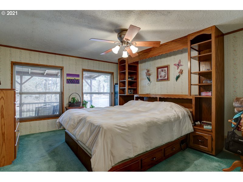 67367 Gist Road Bend, OR 97703 - Photo 9 of 32 a bedroom with a large bed and a large window