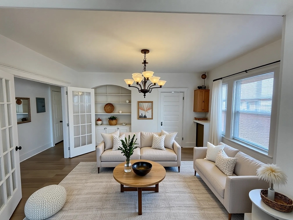 34 Channing Street, Unit 2 Newton, MA 02458 - Photo 1 of 23 a living room with furniture and a chandelier