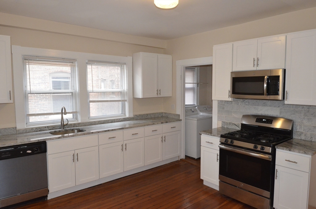 34 Channing Street, Unit 2 Newton, MA 02458 - Photo 12 of 23 a kitchen with granite countertop a sink and steel appliances