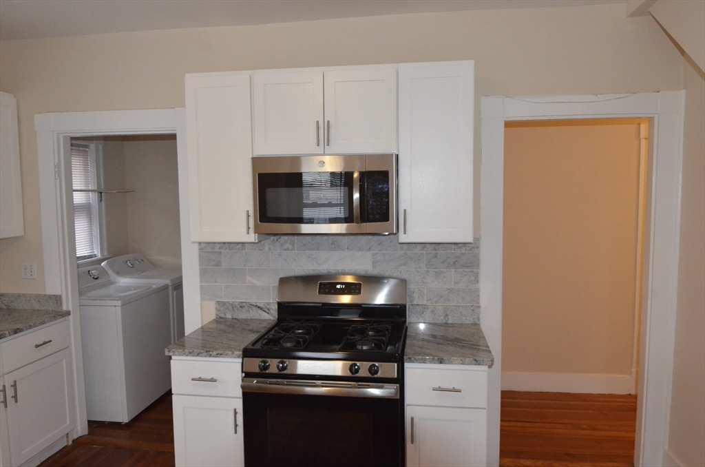 34 Channing Street, Unit 2 Newton, MA 02458 - Photo 13 of 23 a kitchen with a stove and a microwave