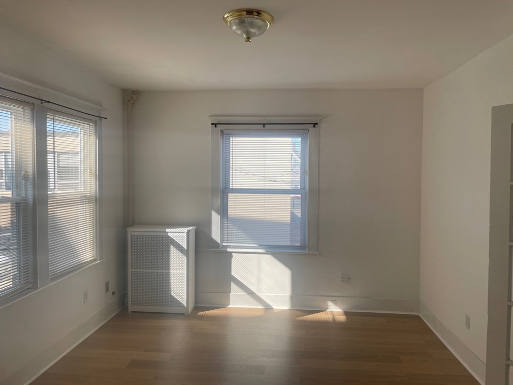 34 Channing Street, Unit 2 Newton, MA 02458 - Photo 22 of 23 a view of empty room with wooden floor and fan