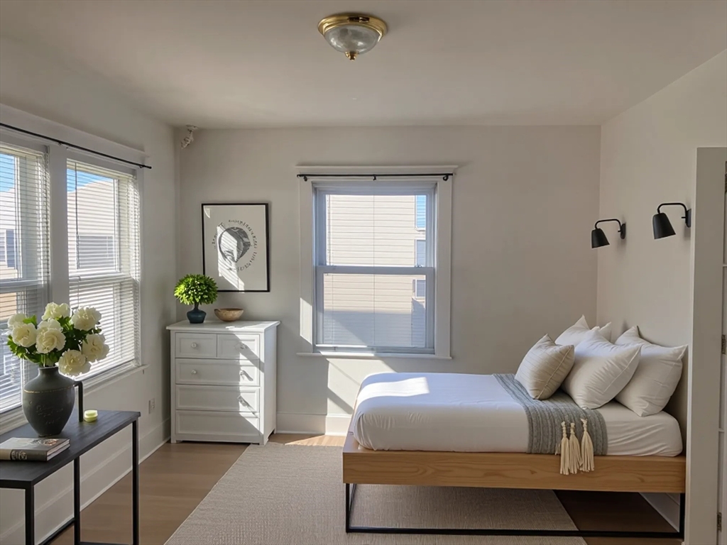 34 Channing Street, Unit 2 Newton, MA 02458 - Photo 5 of 23 a bedroom with a bed and a potted plant