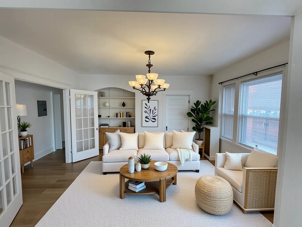34 Channing Street, Unit 2 Newton, MA 02458 - Photo 10 of 23 a living room with furniture and a chandelier