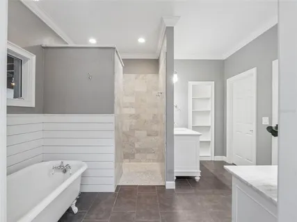 a bathroom with a tub a window and a shower
