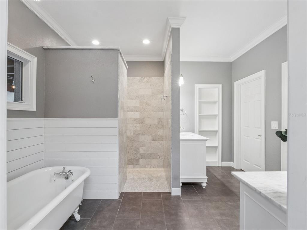 2509 Ridgewind Way Windermere, FL 34786 - Photo 13 of 38 a bathroom with a tub a window and a shower