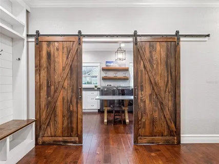 a view of a room with wooden floor and windows