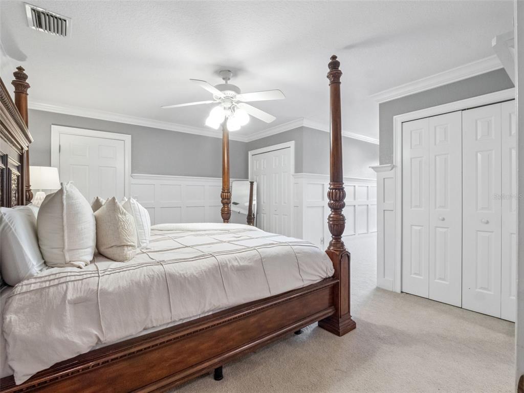 2509 Ridgewind Way Windermere, FL 34786 - Photo 19 of 38 a bedroom with a bed and a chandelier