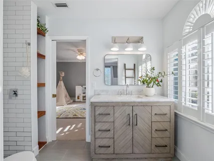 a bathroom with a sink a vanity and mirror