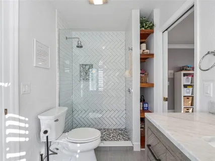 a bathroom with a sink a toilet and shower