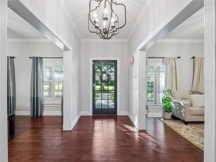 a view of an entryway with wooden floor