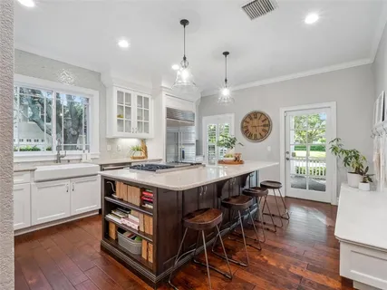 a large kitchen with a table and chairs in it