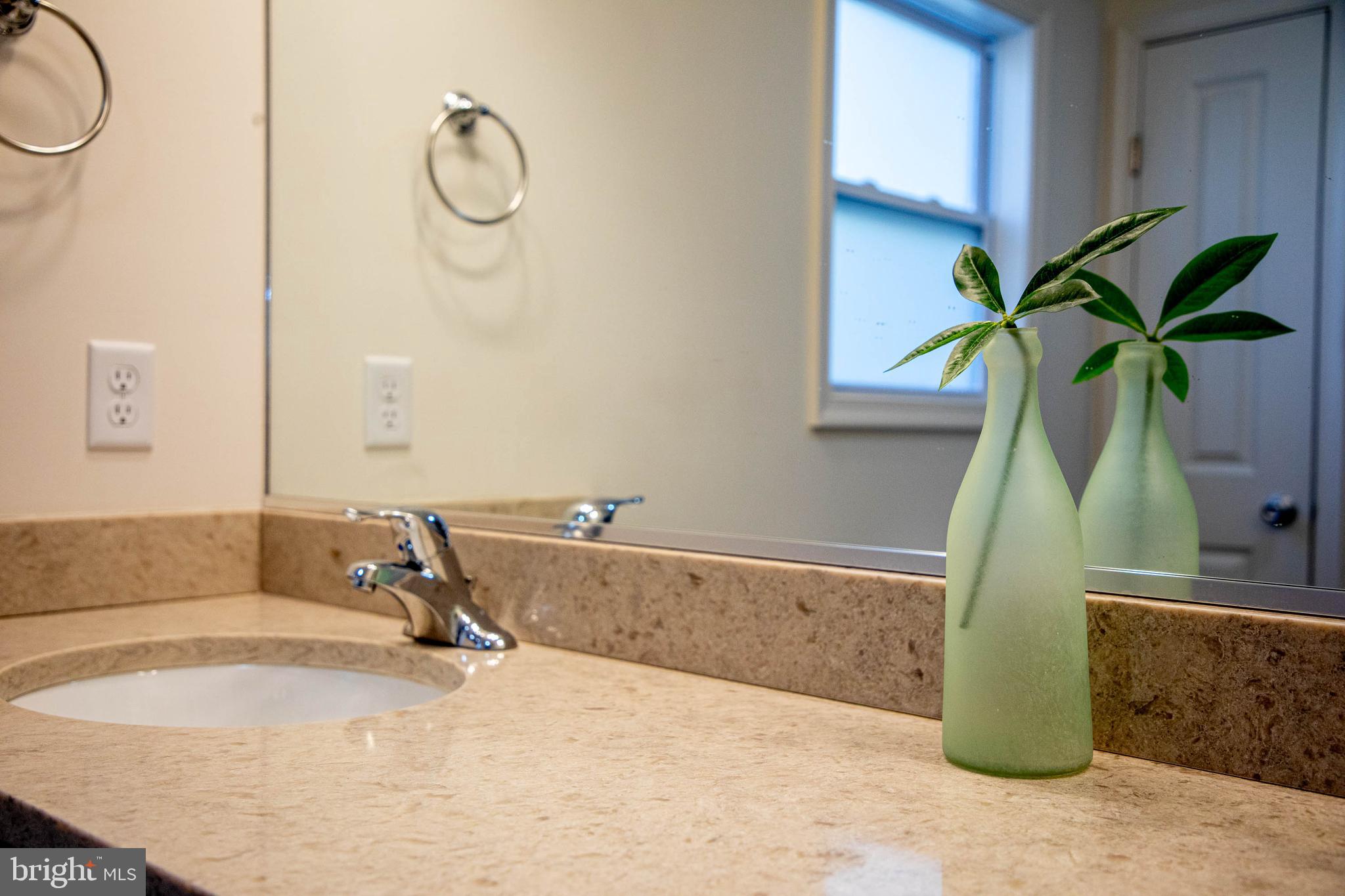 26300 Fire Tower Road Seaford, DE 19973 - Photo 27 of 52 a bathroom with a granite countertop sink a mirror and a shower