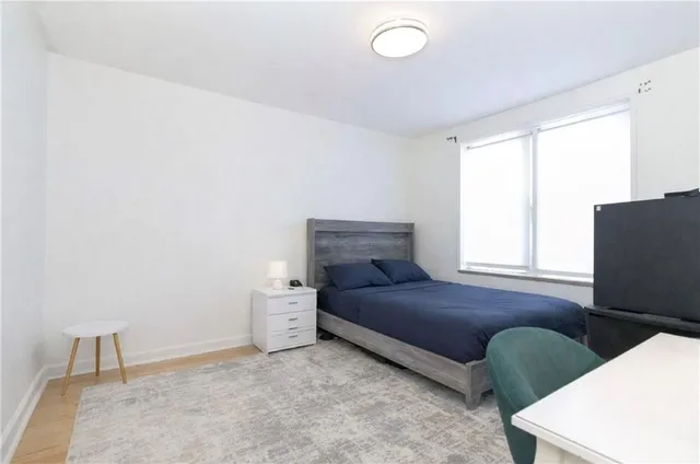 a bedroom with a bed and window