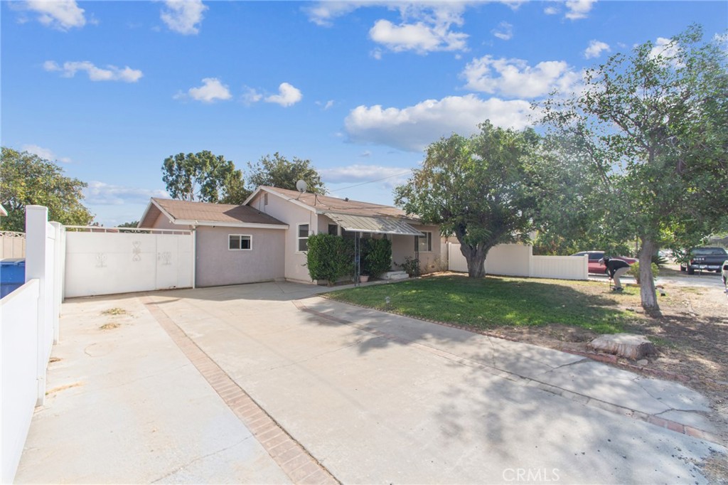 6082 Stearns Street Riverside, CA 92504 - Photo 1 of 1 a front view of a house with a yard and garage