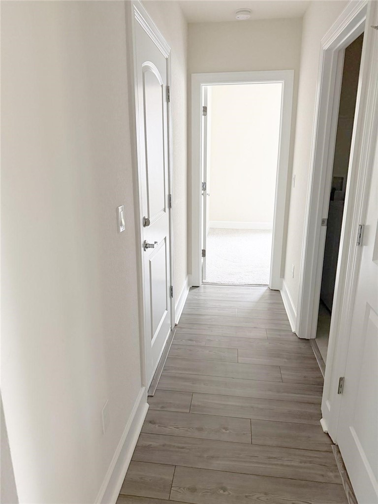 4675 Indigo Way Vero Beach, FL 32967 - Photo 11 of 19 a view of a hallway with wooden floor and a window