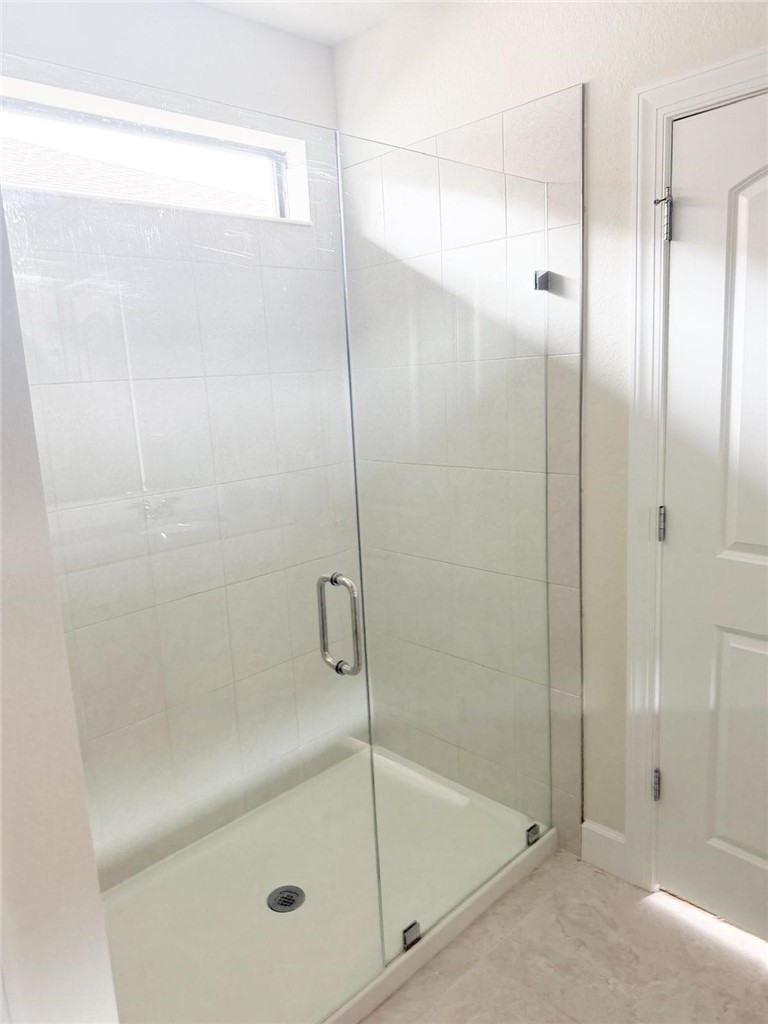 4675 Indigo Way Vero Beach, FL 32967 - Photo 12 of 19 a bathroom with a glass shower door