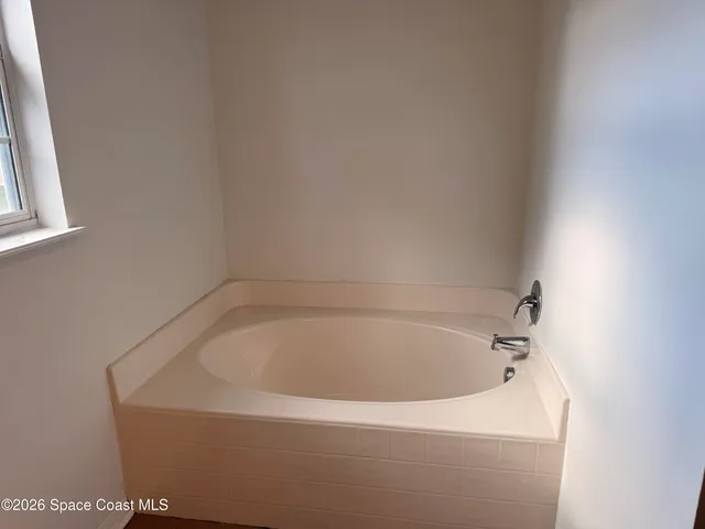 a white bath tub sitting in a bathroom