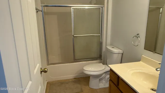 a white toilet sitting next to a bathroom sink