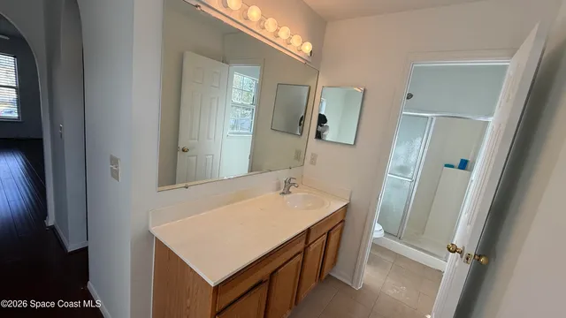 a bathroom with a sink vanity and a mirror
