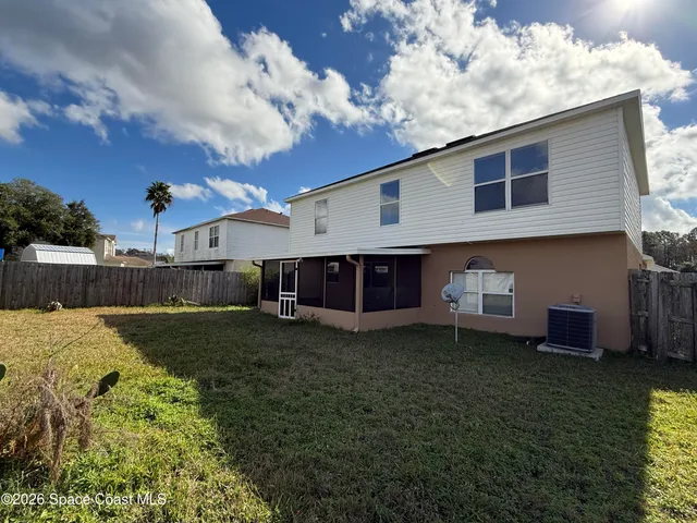 a view of a house with a backyard