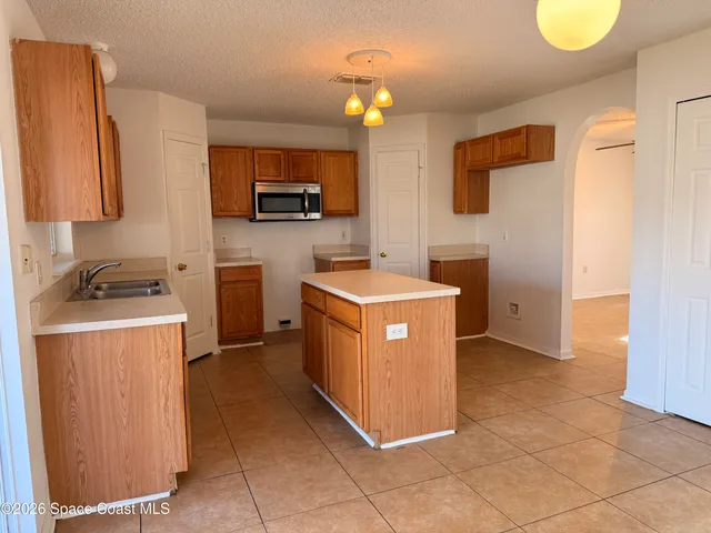 a kitchen with a sink counter top space and cabinets