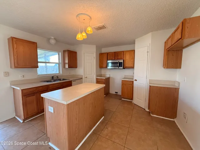 a kitchen that has a sink and a stove in it