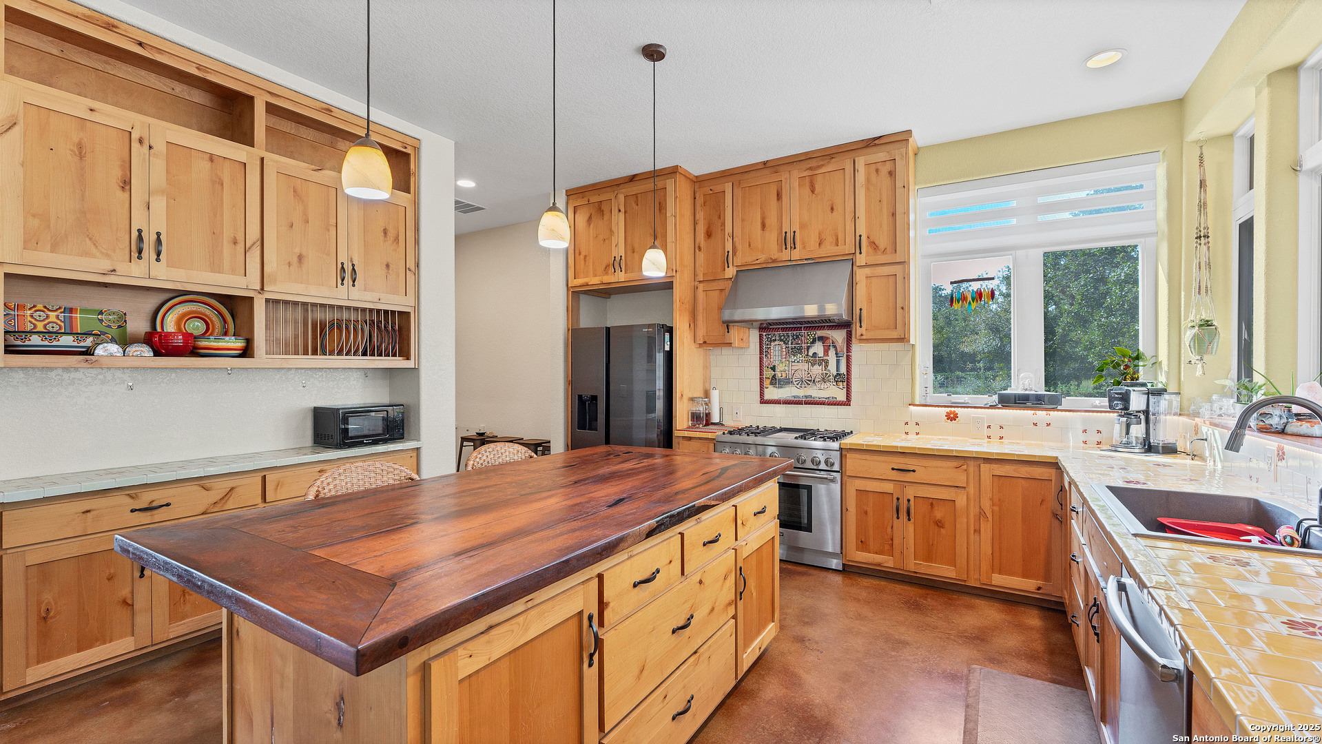 475 Jackson Road Kingsbury, TX 78638 - Photo 14 of 44 a kitchen that has a lot of cabinets in it and wooden floors