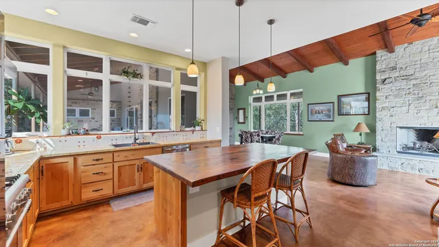 a kitchen with a table chairs and a sink