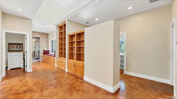 a view of empty room with wooden floor and cabinet