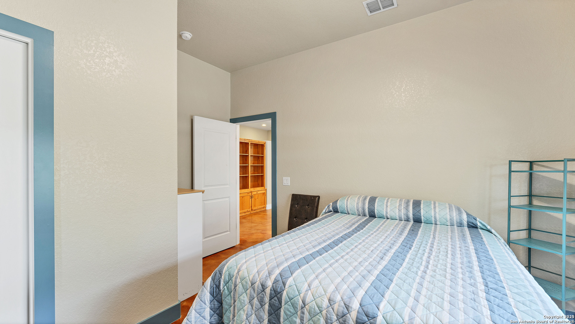 475 Jackson Road Kingsbury, TX 78638 - Photo 30 of 44 a bedroom with a bed and wooden floor