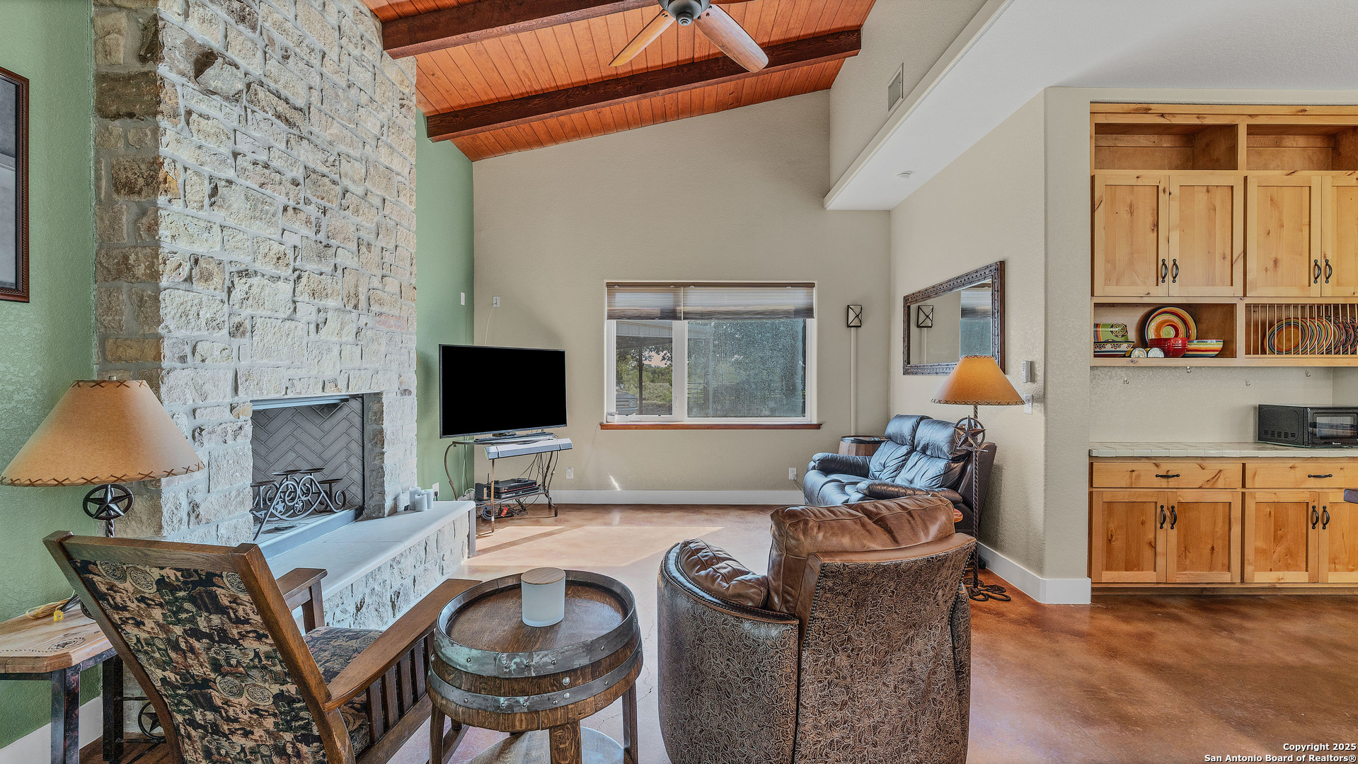 475 Jackson Road Kingsbury, TX 78638 - Photo 9 of 44 a living room with furniture a flat screen tv and a fireplace