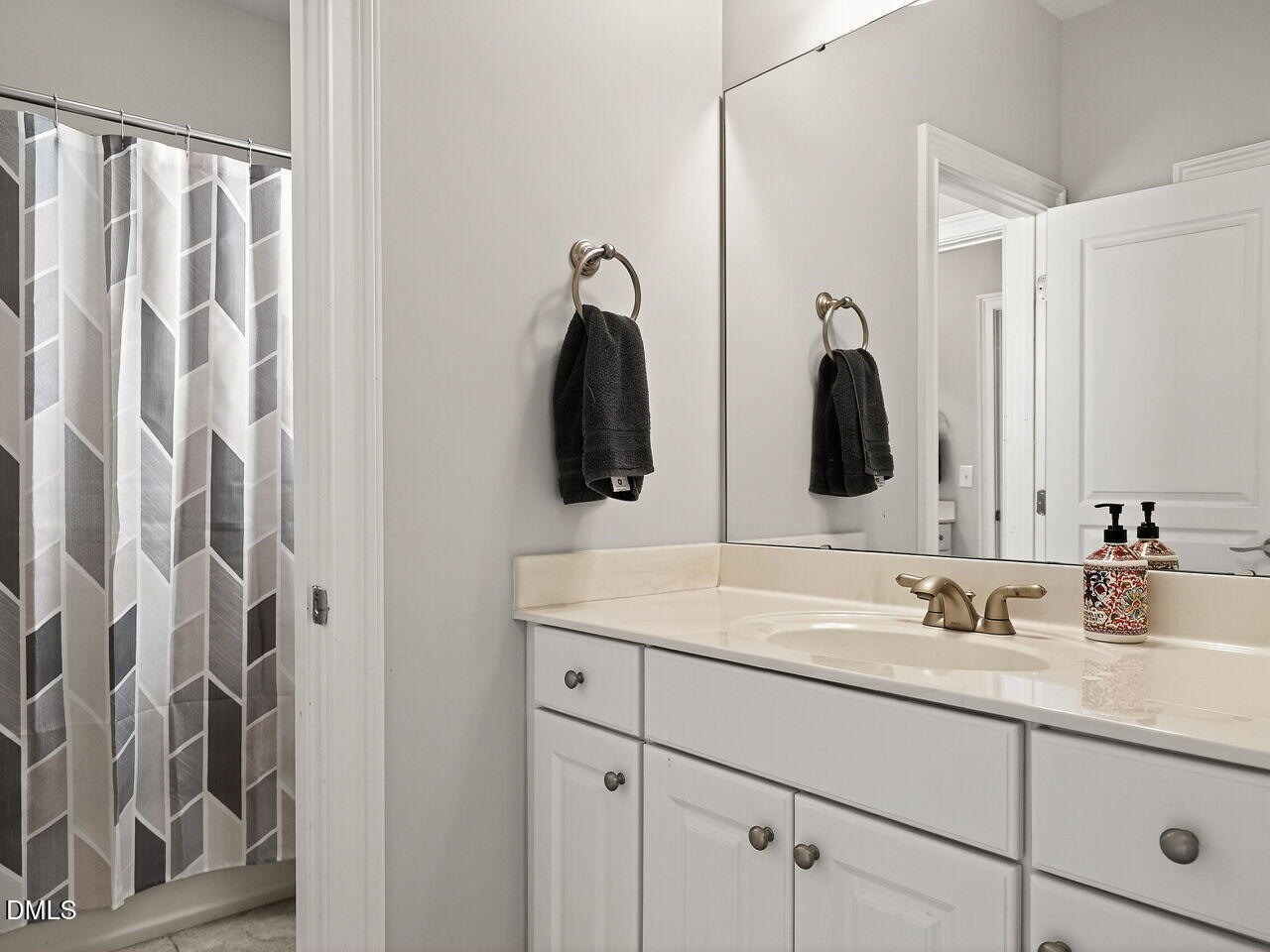 104 River Run Road Durham, NC 27712 - Photo 32 of 41 a bathroom with a double vanity sink and mirror