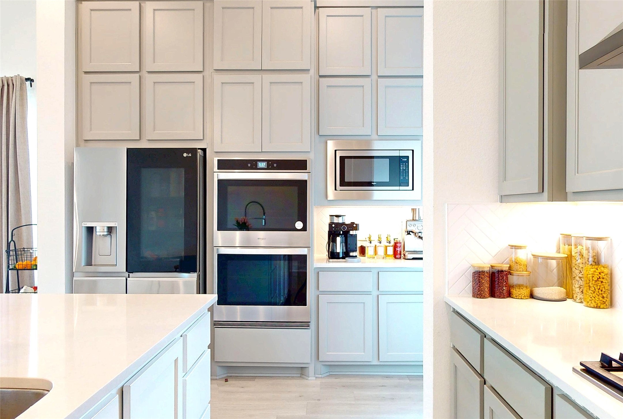 4611 Columbus Drive Manvel, TX 77583 - Photo 4 of 10 a kitchen with stainless steel appliances a stove microwave and cabinets