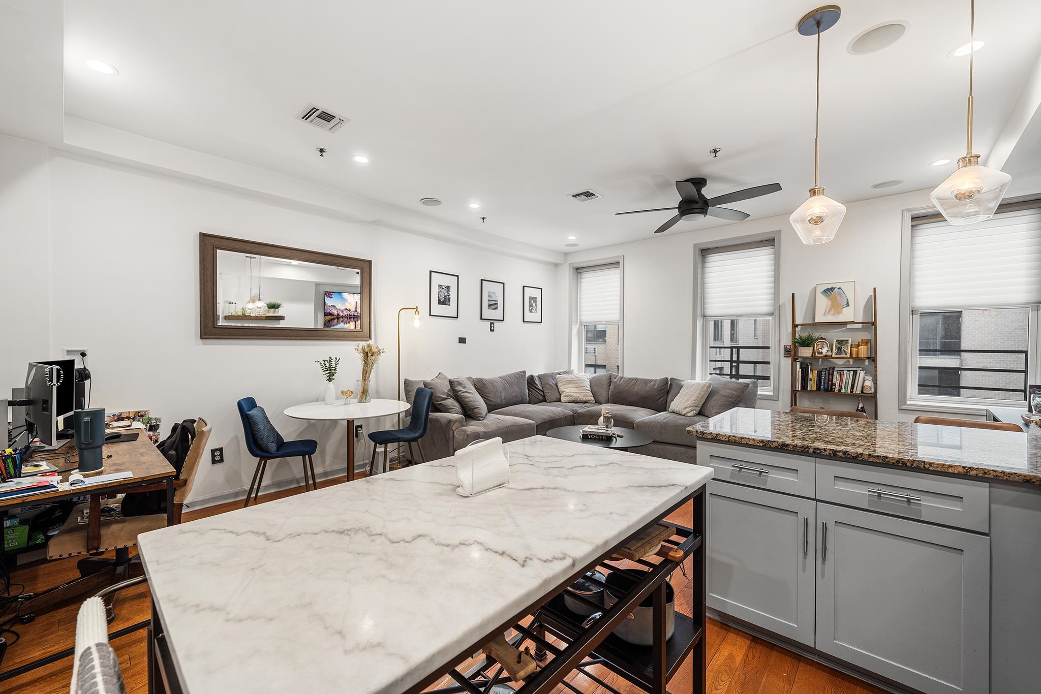 307 1st Street, Unit 2 Hoboken, NJ 07030 - Photo 13 of 20 a open kitchen with stainless steel appliances kitchen island a white counter space a sink and living room view