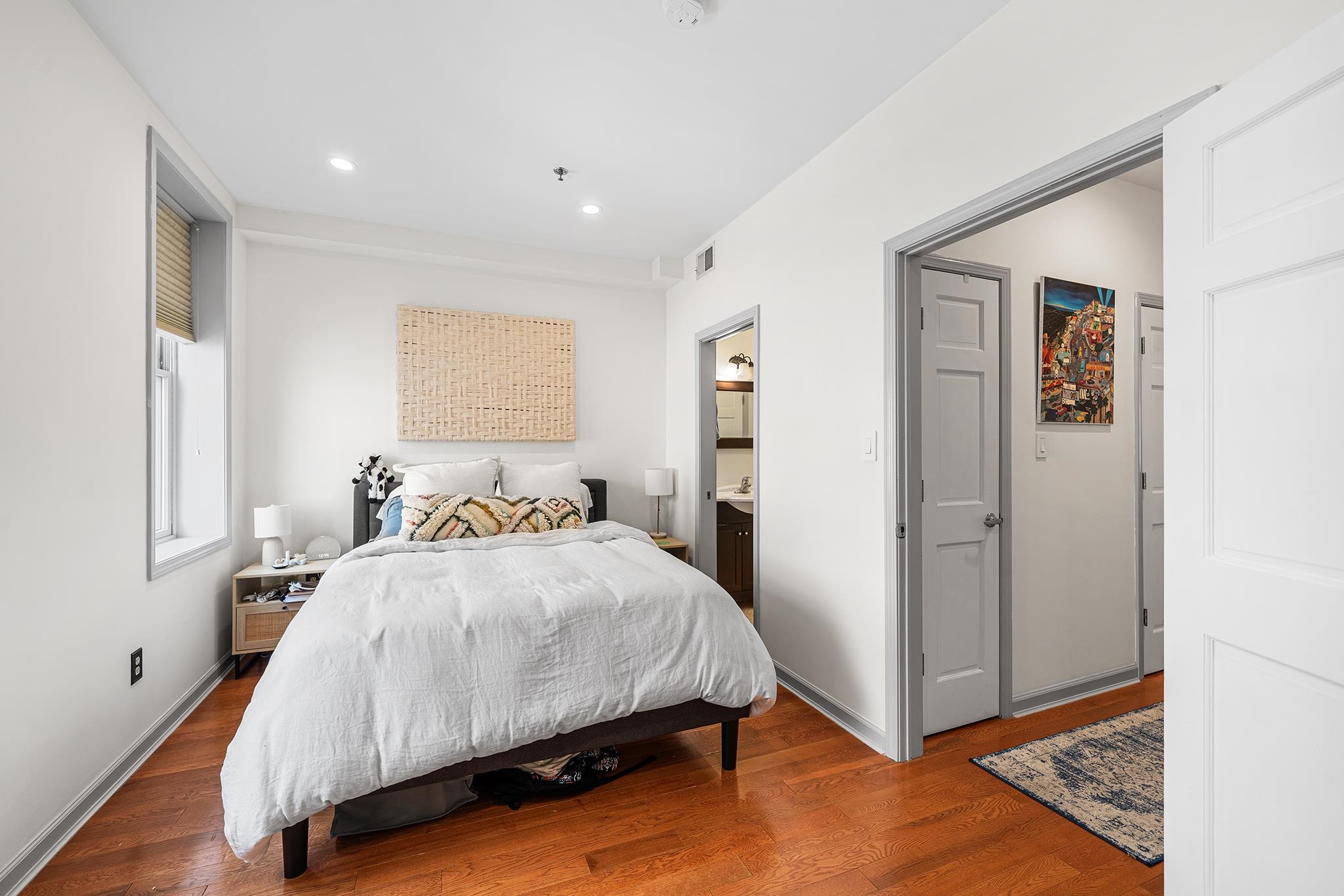 307 1st Street, Unit 2 Hoboken, NJ 07030 - Photo 15 of 20 a bedroom with a bed and a painting on the wall