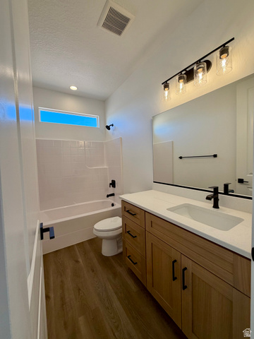 4956 North 925 East, Unit 87 Enoch, UT 84721 - Photo 14 of 19 Bathroom featuring a wood-finish vanity with a white countertop, an integrated rectangular sink, and matte black fixtures