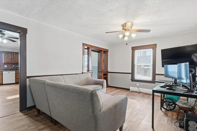 a view of livingroom with hardwood floor and a ceiling fan