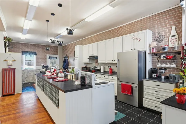 a kitchen with refrigerator and cabinets