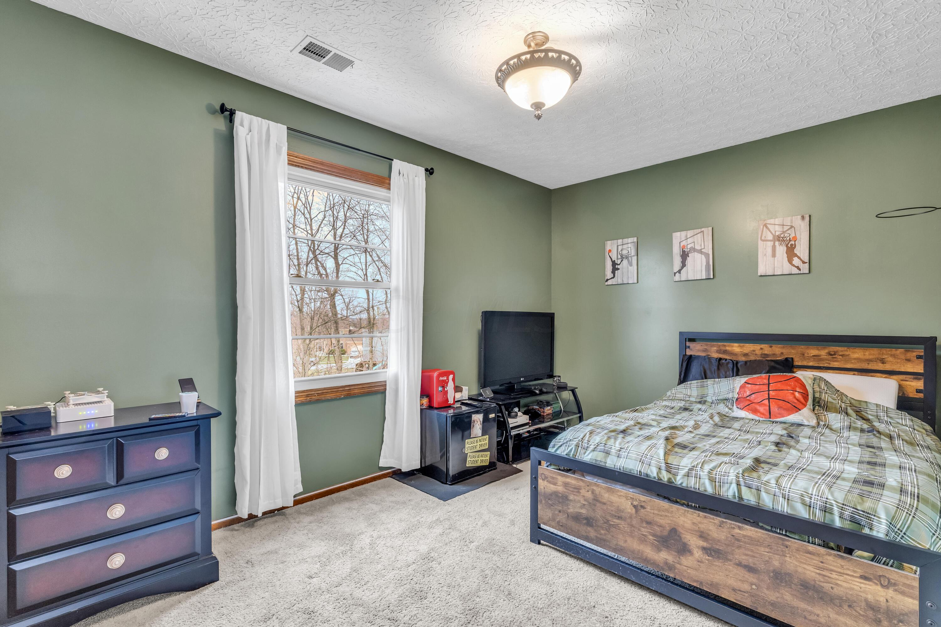 435 Emory Street Gahanna, OH 43230 - Photo 32 of 54 • Light sand carpet
• Olive painted walls
• Ceiling light
• Closet with double
sliding doors
• Drapes