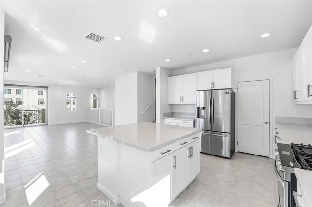 a kitchen with cabinets stainless steel appliances and sink
