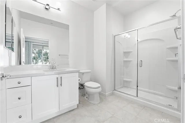 a large white kitchen with a large window