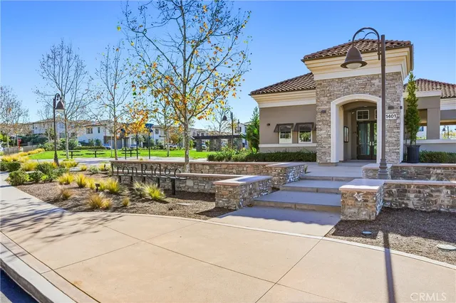 a aerial view of a house with a yard and potted plants