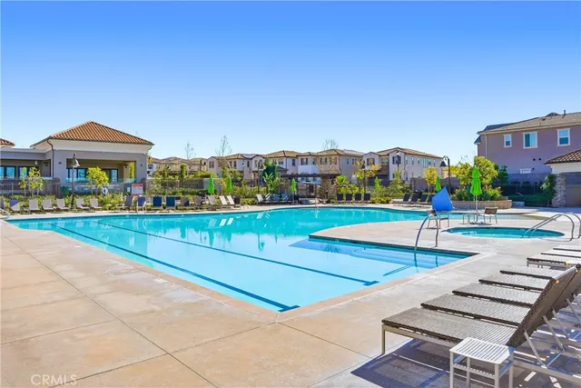 a front view of multi story residential apartment building with yard