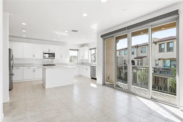 a kitchen with stainless steel appliances a refrigerator and a stove top oven
